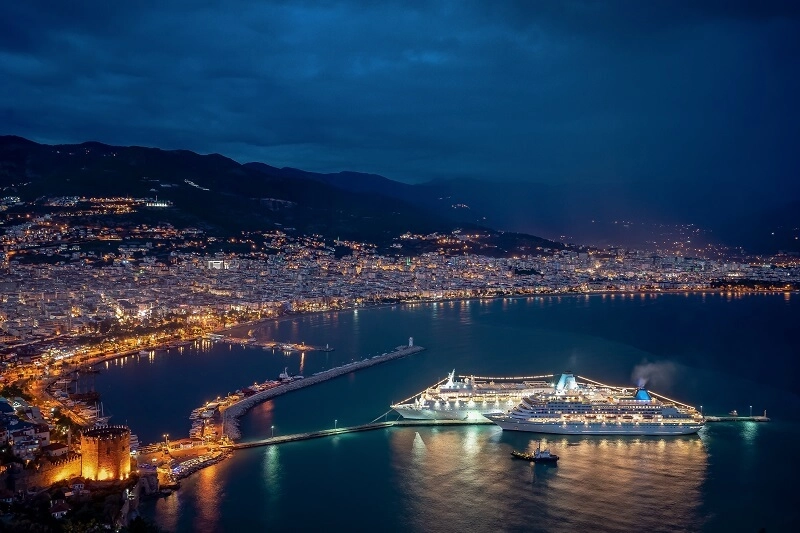 spectacular-night-sea-coast-with-city-cruise-ship-lights-reflected-water
