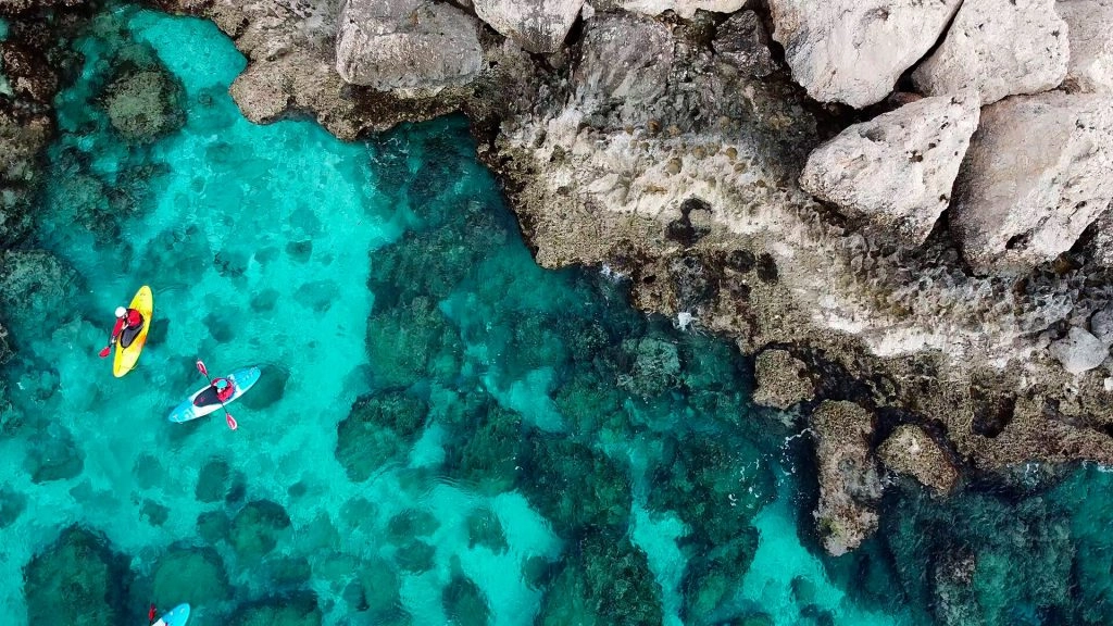 view-drone-from-drone-people-are-kayaking-sea-near-mountains-island-cyprus-ayia-napa-1024x576